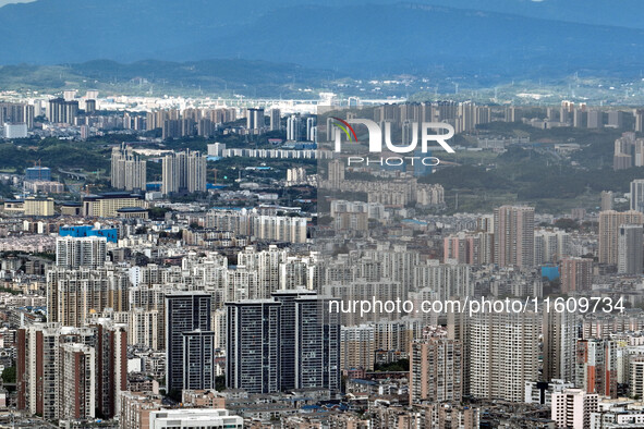 An aerial view shows high-rise buildings lining the riverside city in Yichang, Hubei, China, on September 21, 2024. 