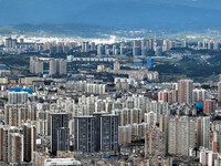 An aerial view shows high-rise buildings lining the riverside city in Yichang, Hubei, China, on September 21, 2024. (