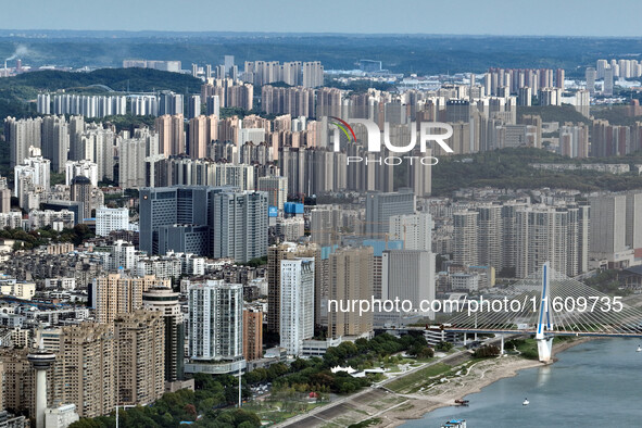 An aerial view shows high-rise buildings lining the riverside city in Yichang, Hubei, China, on September 21, 2024. 