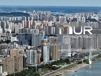 An aerial view shows high-rise buildings lining the riverside city in Yichang, Hubei, China, on September 21, 2024. (