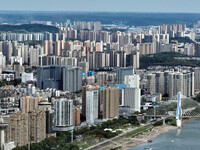 An aerial view shows high-rise buildings lining the riverside city in Yichang, Hubei, China, on September 21, 2024. (