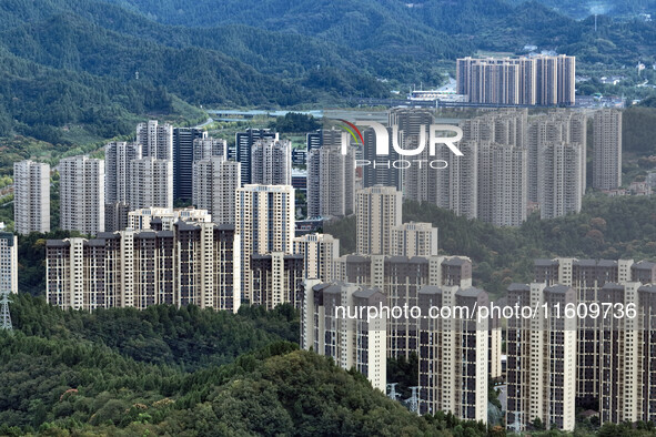 An aerial view shows high-rise buildings lining the riverside city in Yichang, Hubei, China, on September 21, 2024. 