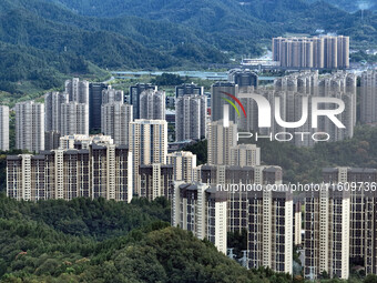 An aerial view shows high-rise buildings lining the riverside city in Yichang, Hubei, China, on September 21, 2024. (