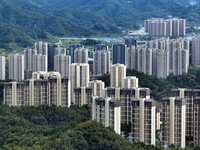 An aerial view shows high-rise buildings lining the riverside city in Yichang, Hubei, China, on September 21, 2024. (