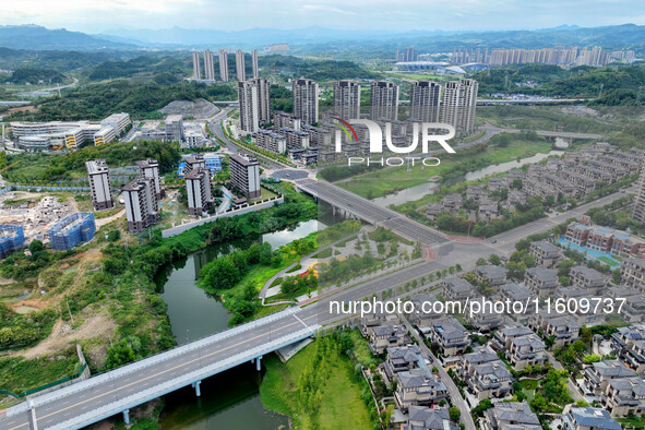 An aerial view shows high-rise buildings lining the riverside city in Yichang, Hubei, China, on September 21, 2024. 