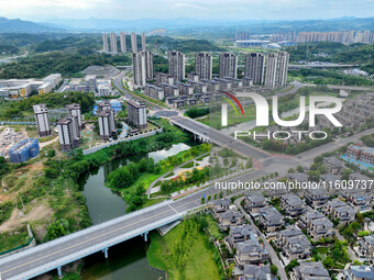 An aerial view shows high-rise buildings lining the riverside city in Yichang, Hubei, China, on September 21, 2024. (