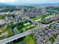 An aerial view shows high-rise buildings lining the riverside city in Yichang, Hubei, China, on September 21, 2024. (