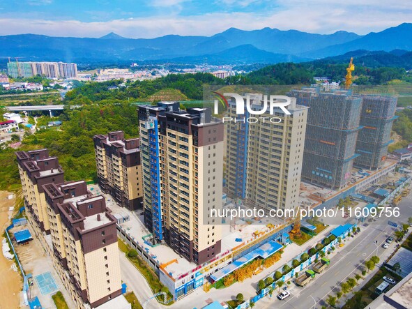 Builders step up construction at the construction site of the Zaofan resettlement area in Yuexi County, Anqing, China, on September 25, 2024...