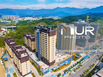 Builders step up construction at the construction site of the Zaofan resettlement area in Yuexi County, Anqing, China, on September 25, 2024...