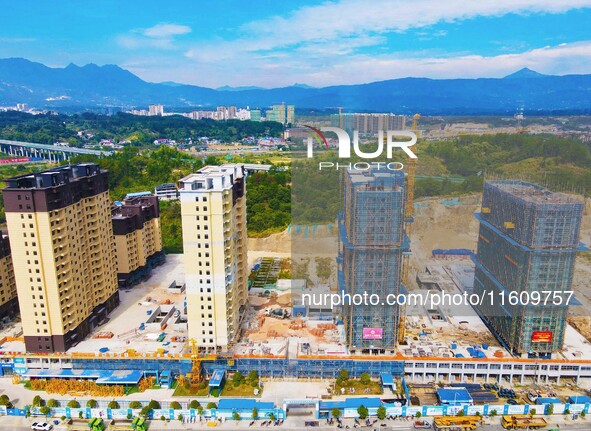 Builders step up construction at the construction site of the Zaofan resettlement area in Yuexi County, Anqing, China, on September 25, 2024...