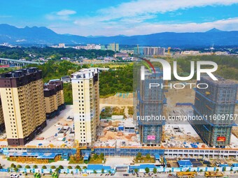 Builders step up construction at the construction site of the Zaofan resettlement area in Yuexi County, Anqing, China, on September 25, 2024...