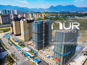 Builders step up construction at the construction site of the Zaofan resettlement area in Yuexi County, Anqing, China, on September 25, 2024...