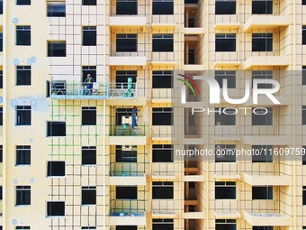 Builders step up construction at the construction site of the Zaofan resettlement area in Yuexi County, Anqing, China, on September 25, 2024...