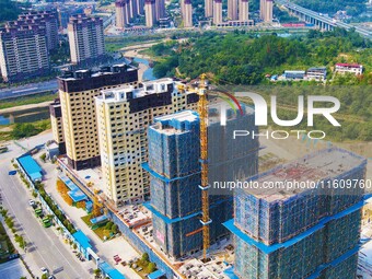 Builders step up construction at the construction site of the Zaofan resettlement area in Yuexi County, Anqing, China, on September 25, 2024...