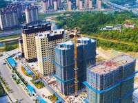 Builders step up construction at the construction site of the Zaofan resettlement area in Yuexi County, Anqing, China, on September 25, 2024...