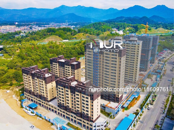 Builders step up construction at the construction site of the Zaofan resettlement area in Yuexi County, Anqing, China, on September 25, 2024...