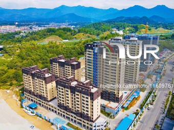 Builders step up construction at the construction site of the Zaofan resettlement area in Yuexi County, Anqing, China, on September 25, 2024...