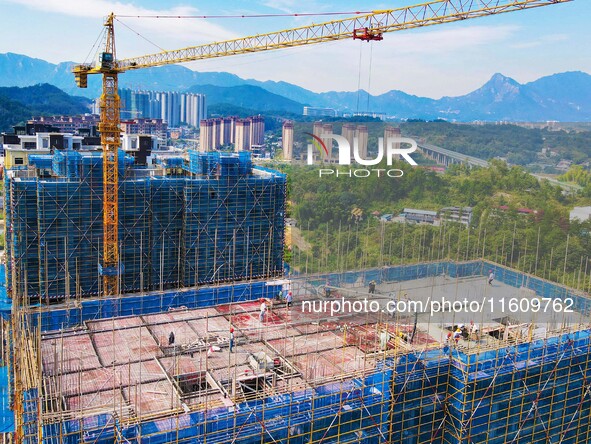 Builders step up construction at the construction site of the Zaofan resettlement area in Yuexi County, Anqing, China, on September 25, 2024...