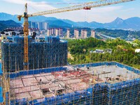 Builders step up construction at the construction site of the Zaofan resettlement area in Yuexi County, Anqing, China, on September 25, 2024...