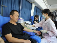 Primary school teachers donate blood on a mobile blood collection vehicle in Yancheng, China, on September 26, 2024. (