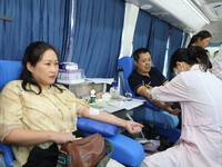 Primary school teachers donate blood on a mobile blood collection vehicle in Yancheng, China, on September 26, 2024. (