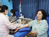 Primary school teachers donate blood on a mobile blood collection vehicle in Yancheng, China, on September 26, 2024. (