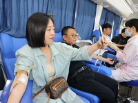 Primary school teachers donate blood on a mobile blood collection vehicle in Yancheng, China, on September 26, 2024. (