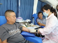 Primary school teachers donate blood on a mobile blood collection vehicle in Yancheng, China, on September 26, 2024. (