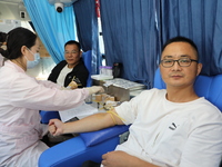 Primary school teachers donate blood on a mobile blood collection vehicle in Yancheng, China, on September 26, 2024. (