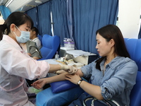 Primary school teachers donate blood on a mobile blood collection vehicle in Yancheng, China, on September 26, 2024. (