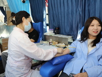 Primary school teachers donate blood on a mobile blood collection vehicle in Yancheng, China, on September 26, 2024. (