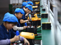 Workers work at a mobile energy storage power production workshop of an electric company in Fuyang, China, on September 26, 2024. (