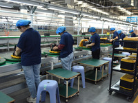 Workers work at a mobile energy storage power production workshop of an electric company in Fuyang, China, on September 26, 2024. (