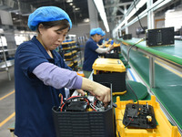 Workers work at a mobile energy storage power production workshop of an electric company in Fuyang, China, on September 26, 2024. (