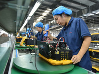 Workers work at a mobile energy storage power production workshop of an electric company in Fuyang, China, on September 26, 2024. (