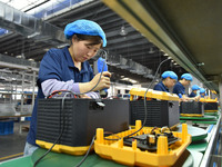 Workers work at a mobile energy storage power production workshop of an electric company in Fuyang, China, on September 26, 2024. (