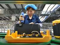 Workers work at a mobile energy storage power production workshop of an electric company in Fuyang, China, on September 26, 2024. (