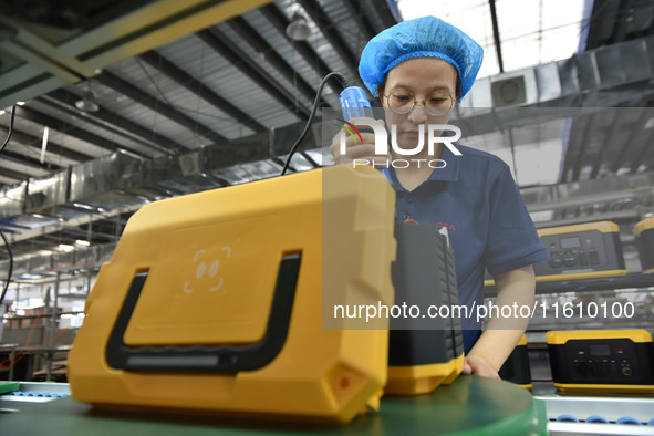 Workers work at a mobile energy storage power production workshop of an electric company in Fuyang, China, on September 26, 2024. 