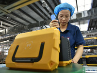 Workers work at a mobile energy storage power production workshop of an electric company in Fuyang, China, on September 26, 2024. (