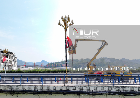 National flags are displayed on the Qiyan Bridge to celebrate China's National Day in Tongren, China, on September 26, 2024. 