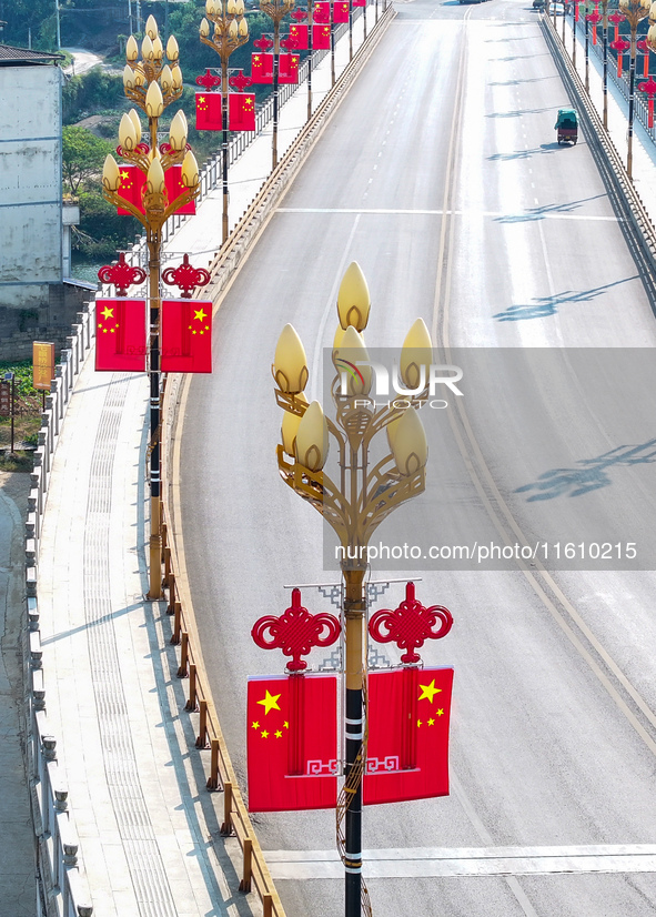 National flags are displayed on the Qiyan Bridge to celebrate China's National Day in Tongren, China, on September 26, 2024. 