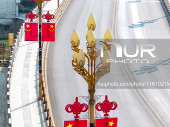 National flags are displayed on the Qiyan Bridge to celebrate China's National Day in Tongren, China, on September 26, 2024. (