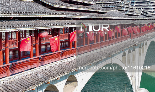 National flags are displayed on the Qiyan Bridge to celebrate China's National Day in Tongren, China, on September 26, 2024. 