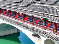 National flags are displayed on the Qiyan Bridge to celebrate China's National Day in Tongren, China, on September 26, 2024. (