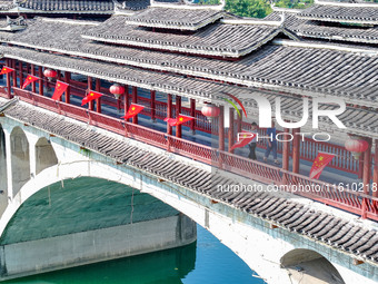 National flags are displayed on the Qiyan Bridge to celebrate China's National Day in Tongren, China, on September 26, 2024. (