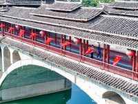 National flags are displayed on the Qiyan Bridge to celebrate China's National Day in Tongren, China, on September 26, 2024. (