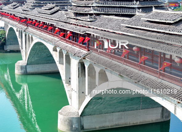 National flags are displayed on the Qiyan Bridge to celebrate China's National Day in Tongren, China, on September 26, 2024. 