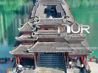 National flags are displayed on the Qiyan Bridge to celebrate China's National Day in Tongren, China, on September 26, 2024. (