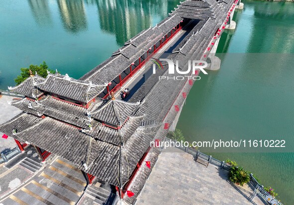 National flags are displayed on the Qiyan Bridge to celebrate China's National Day in Tongren, China, on September 26, 2024. 