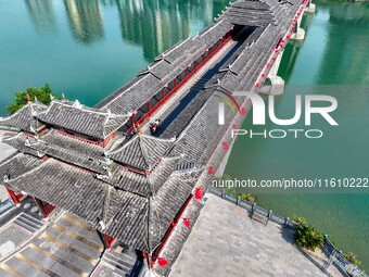 National flags are displayed on the Qiyan Bridge to celebrate China's National Day in Tongren, China, on September 26, 2024. (